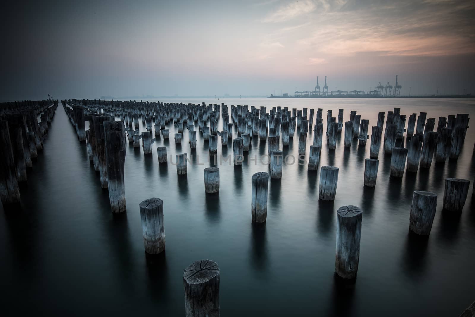 The historic Princes Pier featuring many disused pylons on a hot summer's day in Port Melbourme, Australia