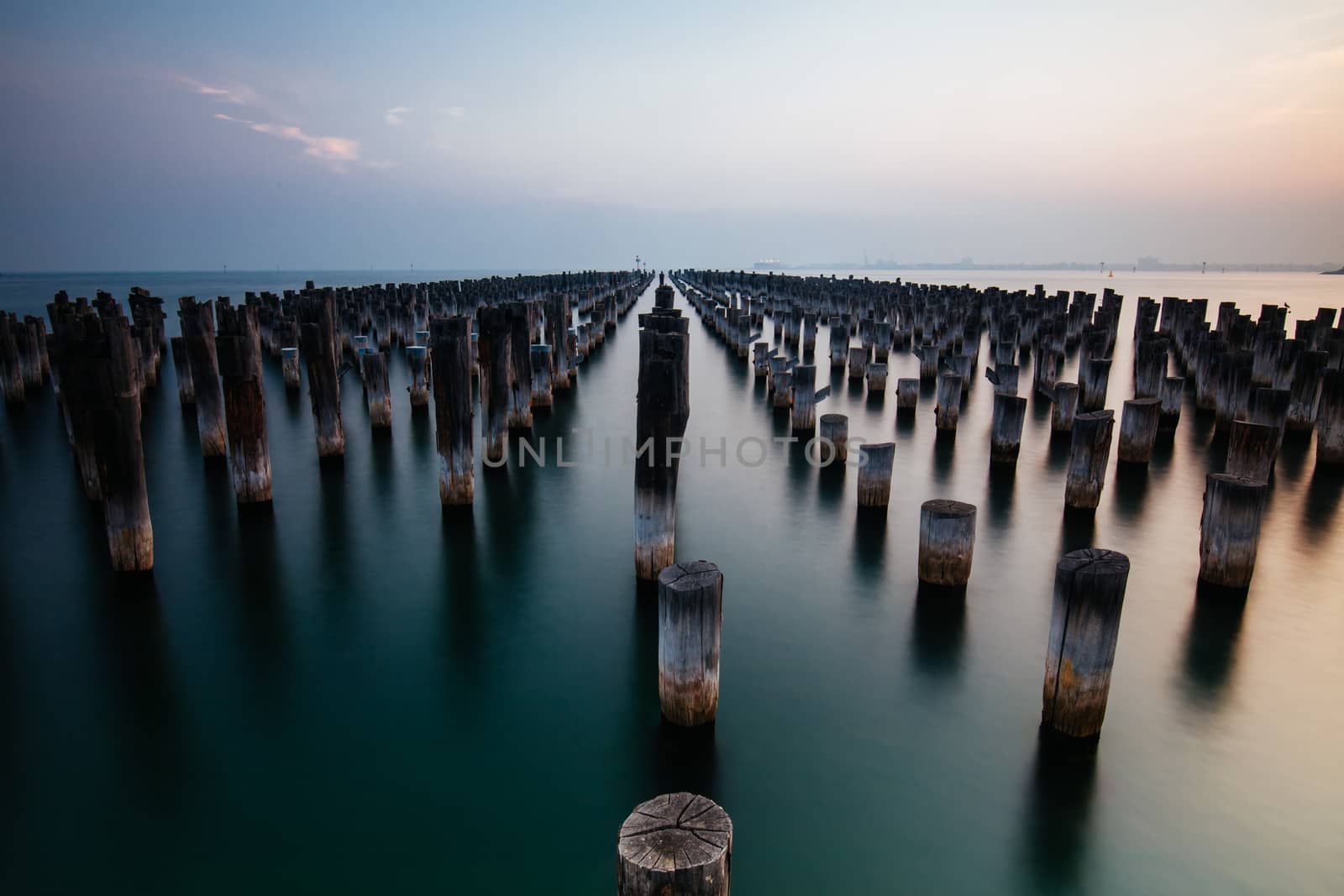 The historic Princes Pier featuring many disused pylons on a hot summer's day in Port Melbourme, Australia