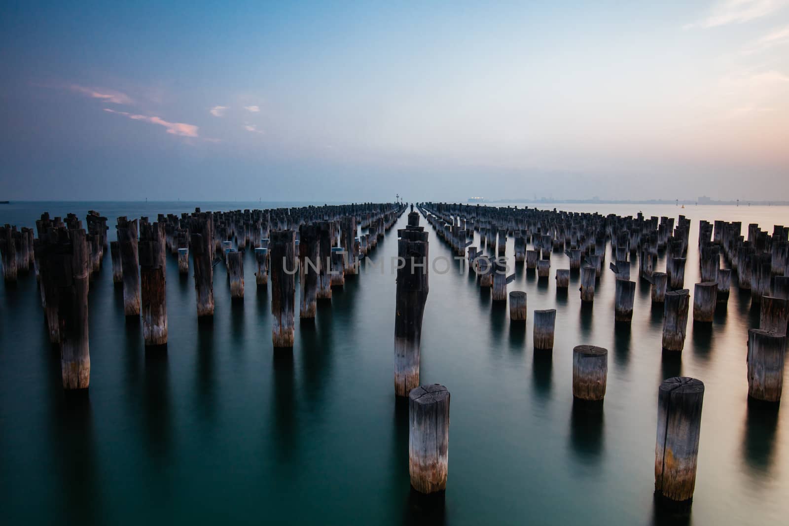 The historic Princes Pier featuring many disused pylons on a hot summer's day in Port Melbourme, Australia