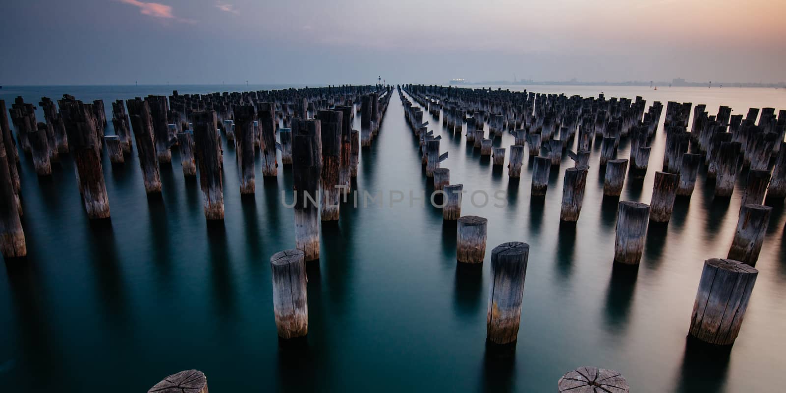 The historic Princes Pier featuring many disused pylons on a hot summer's day in Port Melbourme, Australia