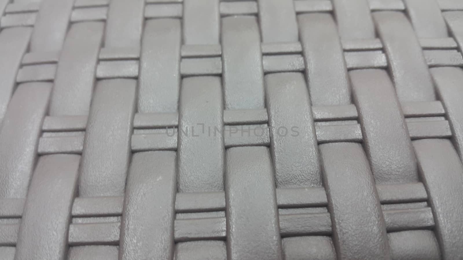 Grey plastic woven stripes of traditional bed, chair or sitting stool used in rural areas.