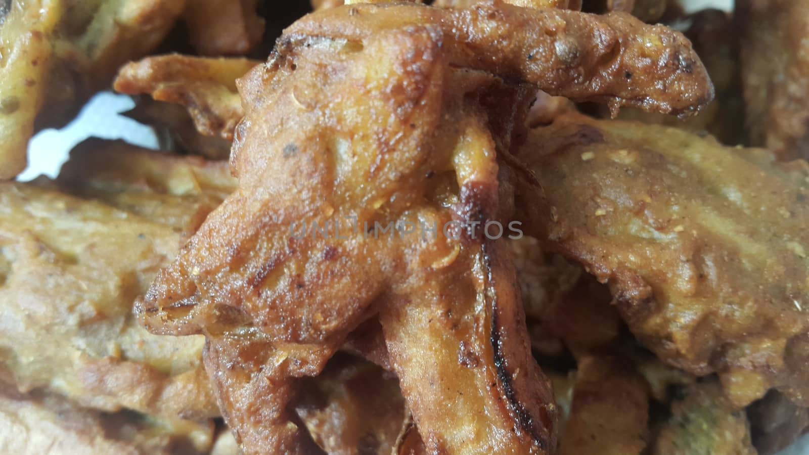 Crispy basin pakora/pakoda or patties are popular indian or pakistani street food snack, served with green salad and sauce. Selective focus of