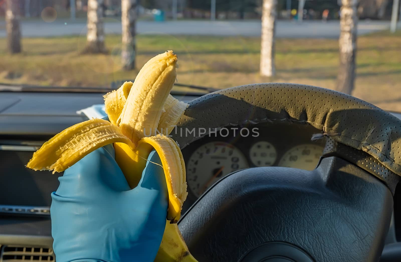 quick, safe food, banana in the car driver hand