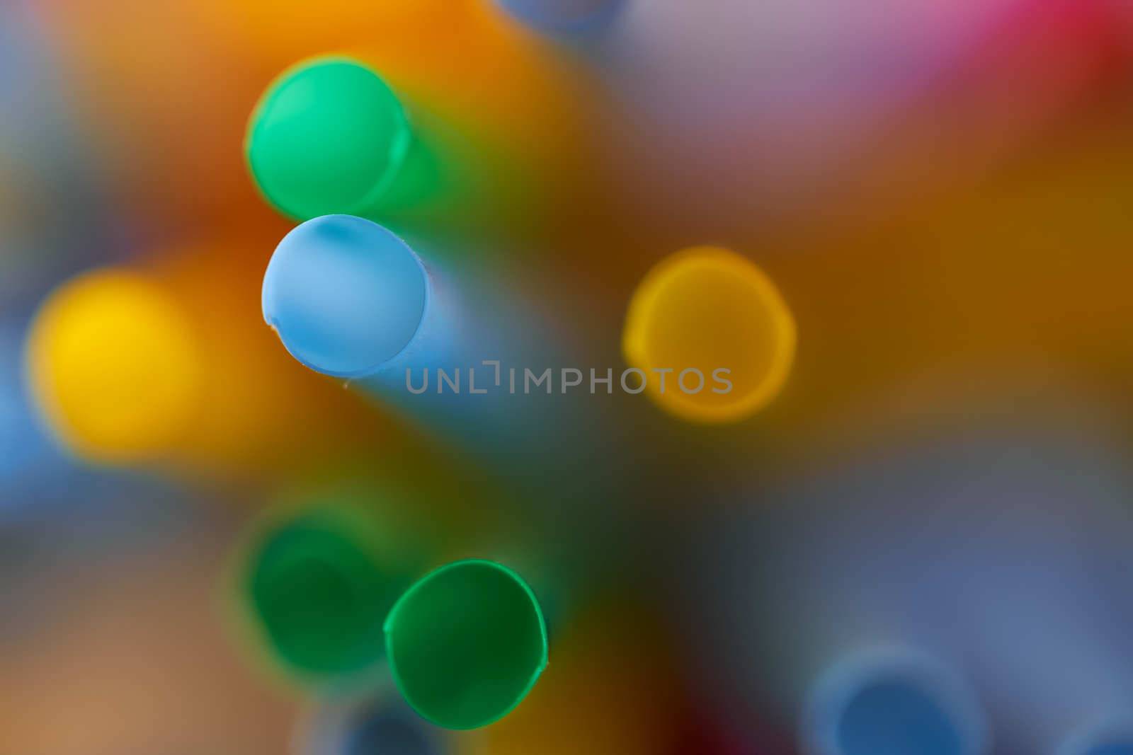 Blurred Background Multicolored Plastic Drinks Tubes. High quality photo