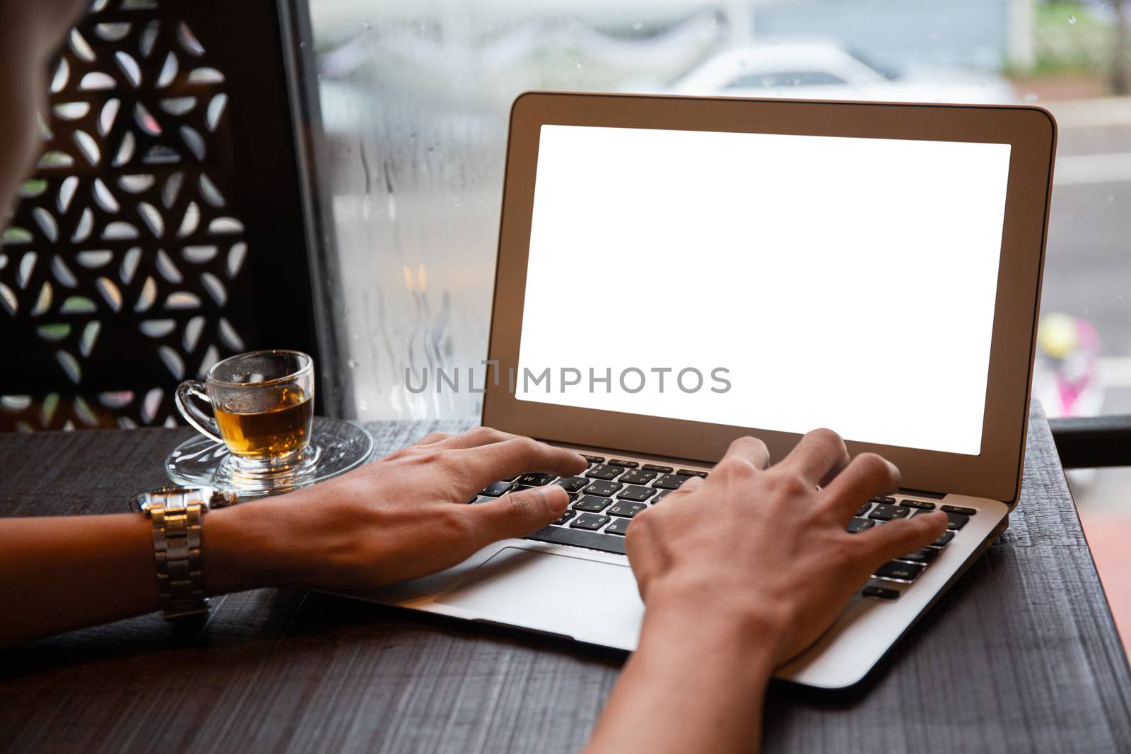 Young entrepreneur SME use notebook showing blank screen with clipping path display  in cafe concept. Hand of business man hold smartphone People use 5G cellular work app with modern internet of things 