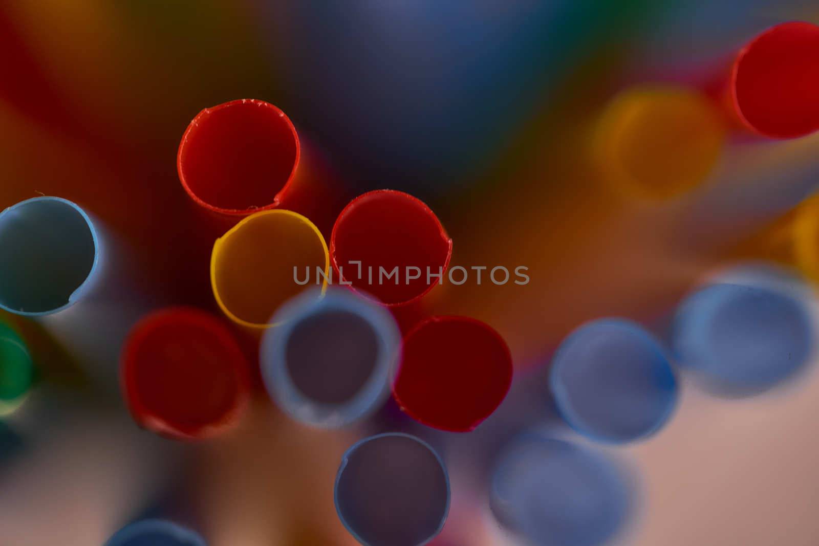 Blurred Background Multicolored Plastic Drinks Tubes. High quality photo