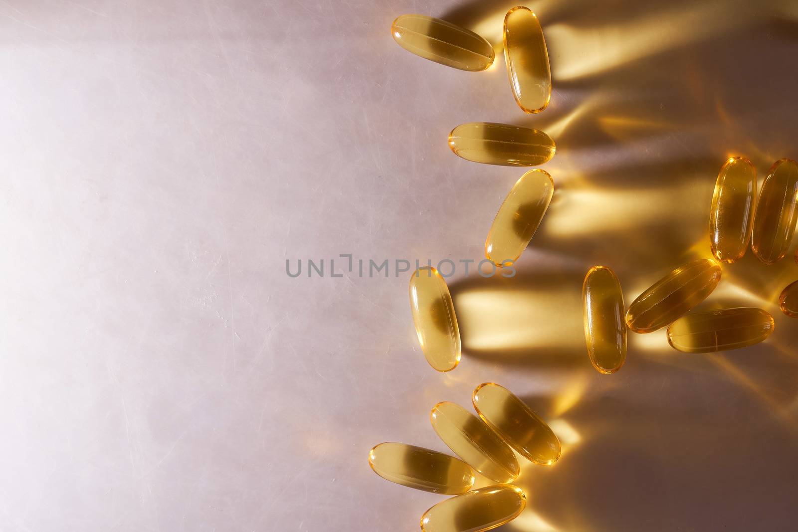 Golden Capsules Omega 3 Vitamins Lie On White Background. High quality photo