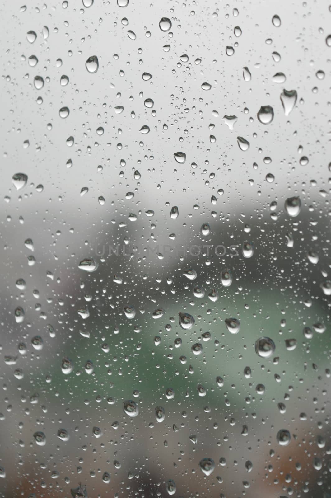 Drops of rain on the window, rainy day. Shallow DOF