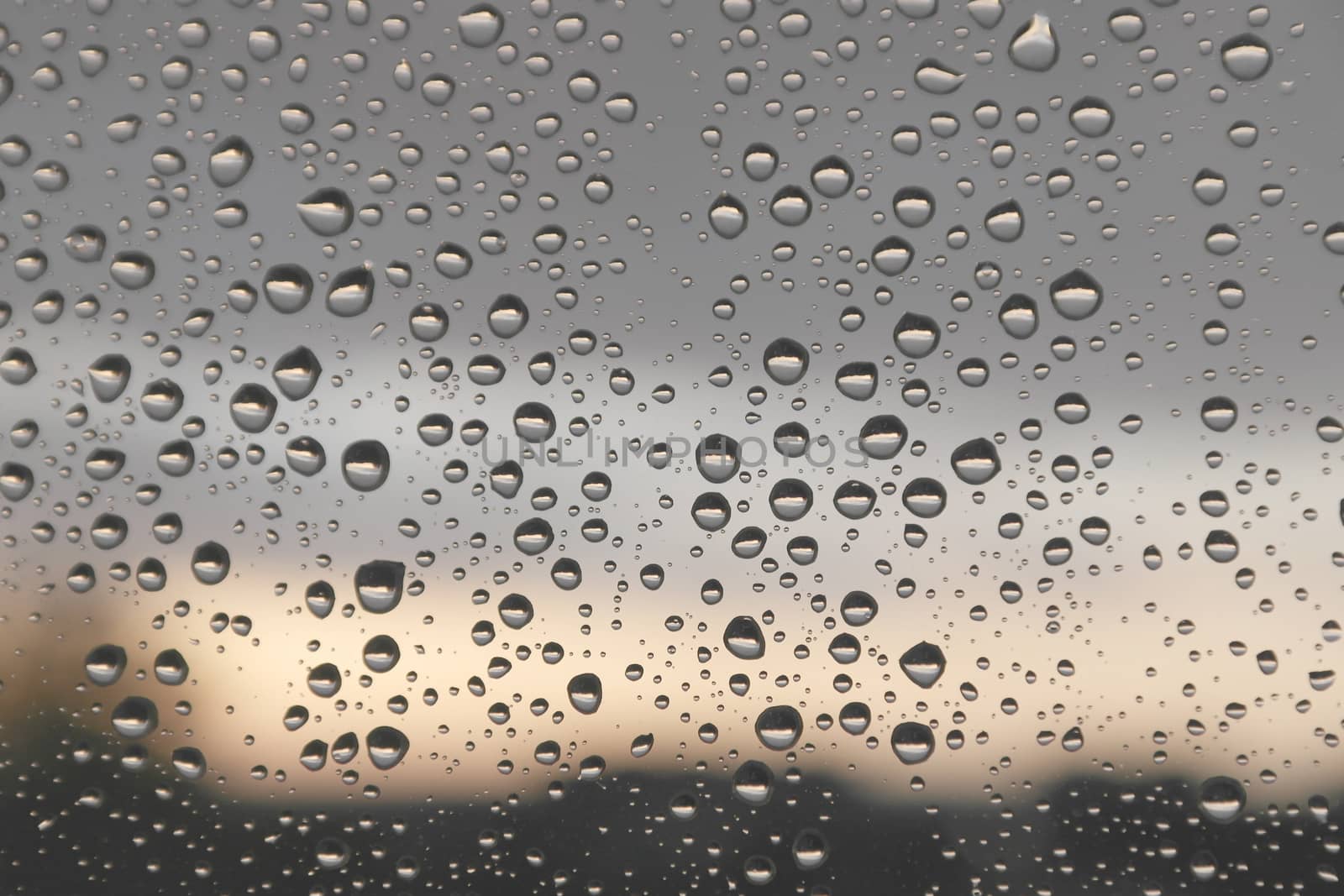 Drops of rain on the window, rainy day. Shallow DOF