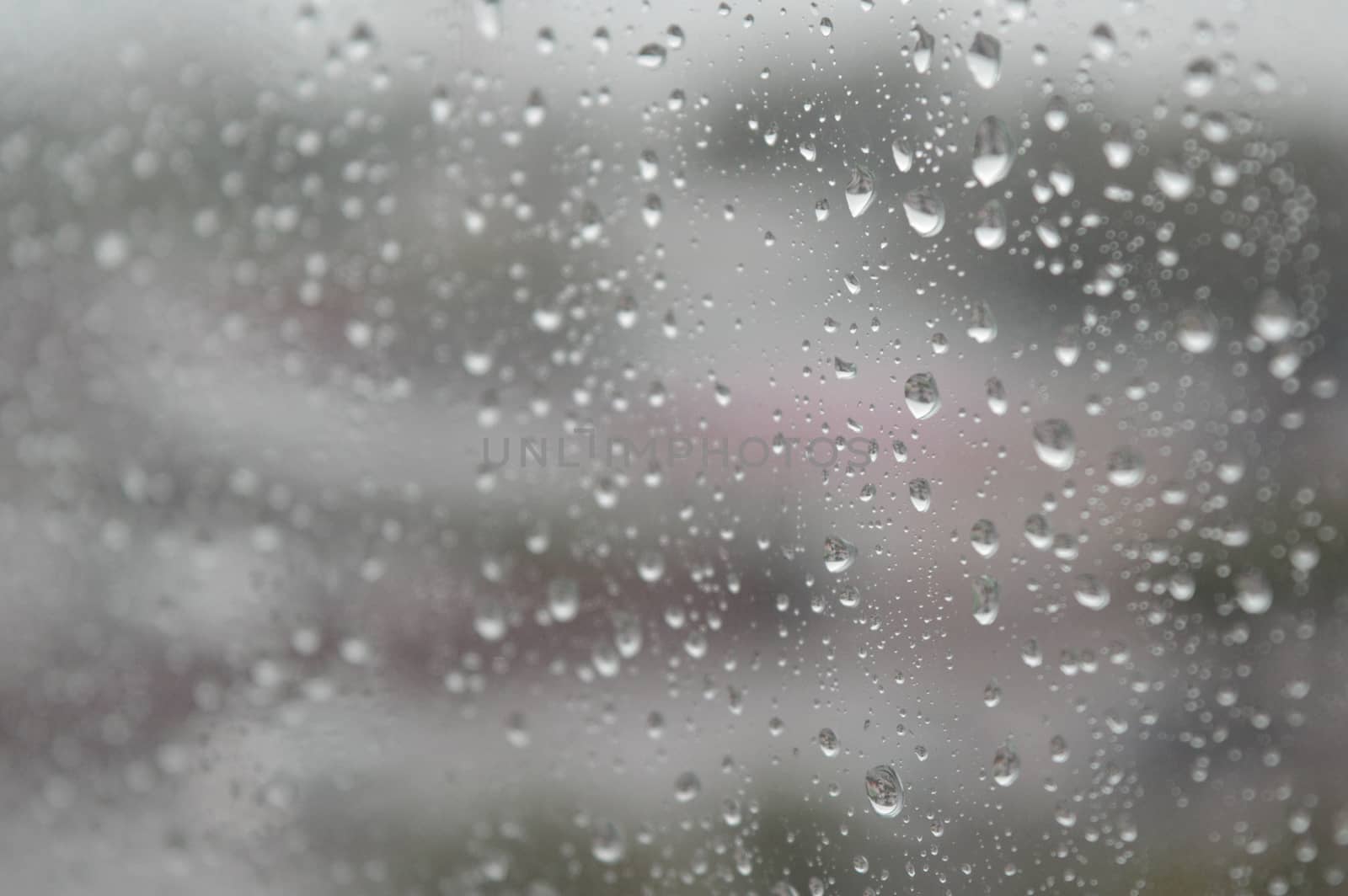 Drops of rain on the window, rainy day. Shallow DOF