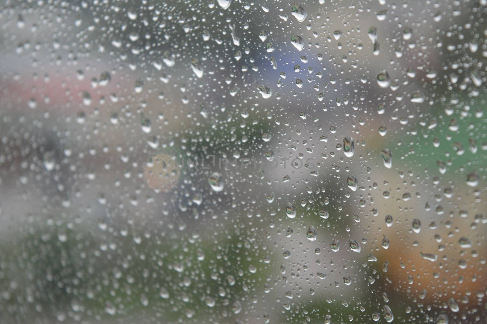 Drops of rain on the window, rainy day. Shallow DOF