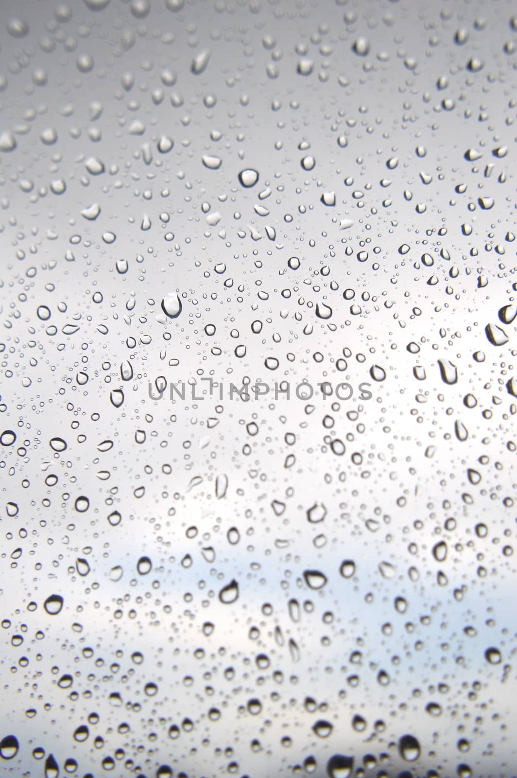 Drops of rain on the window, rainy day. Shallow DOF