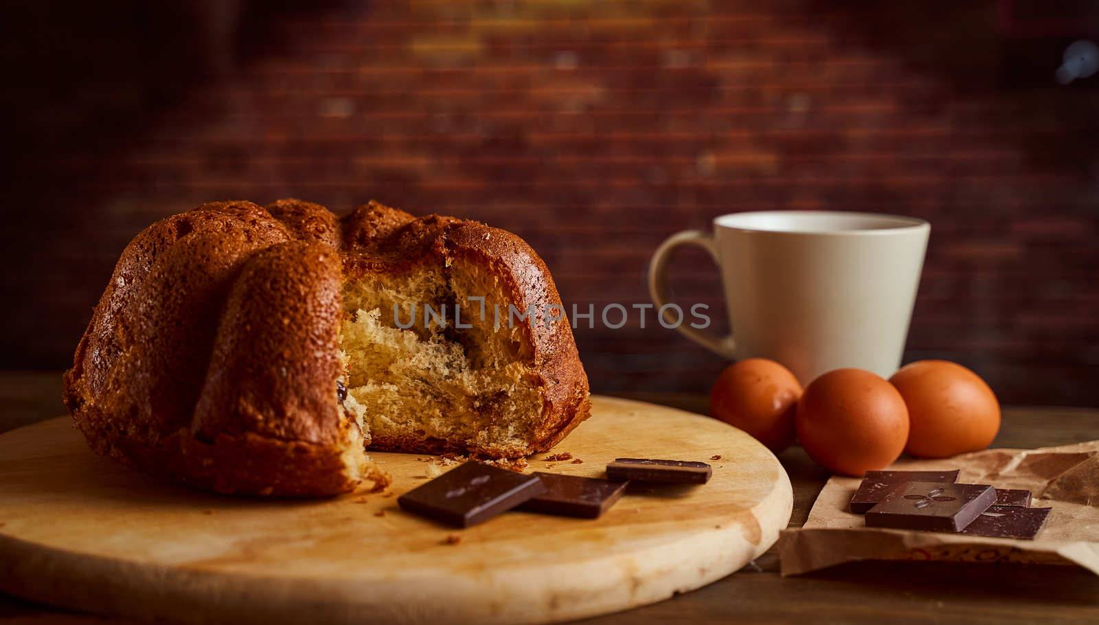 Cut homemade cupcake with chocolate cream inside on a wooden board. High quality photo