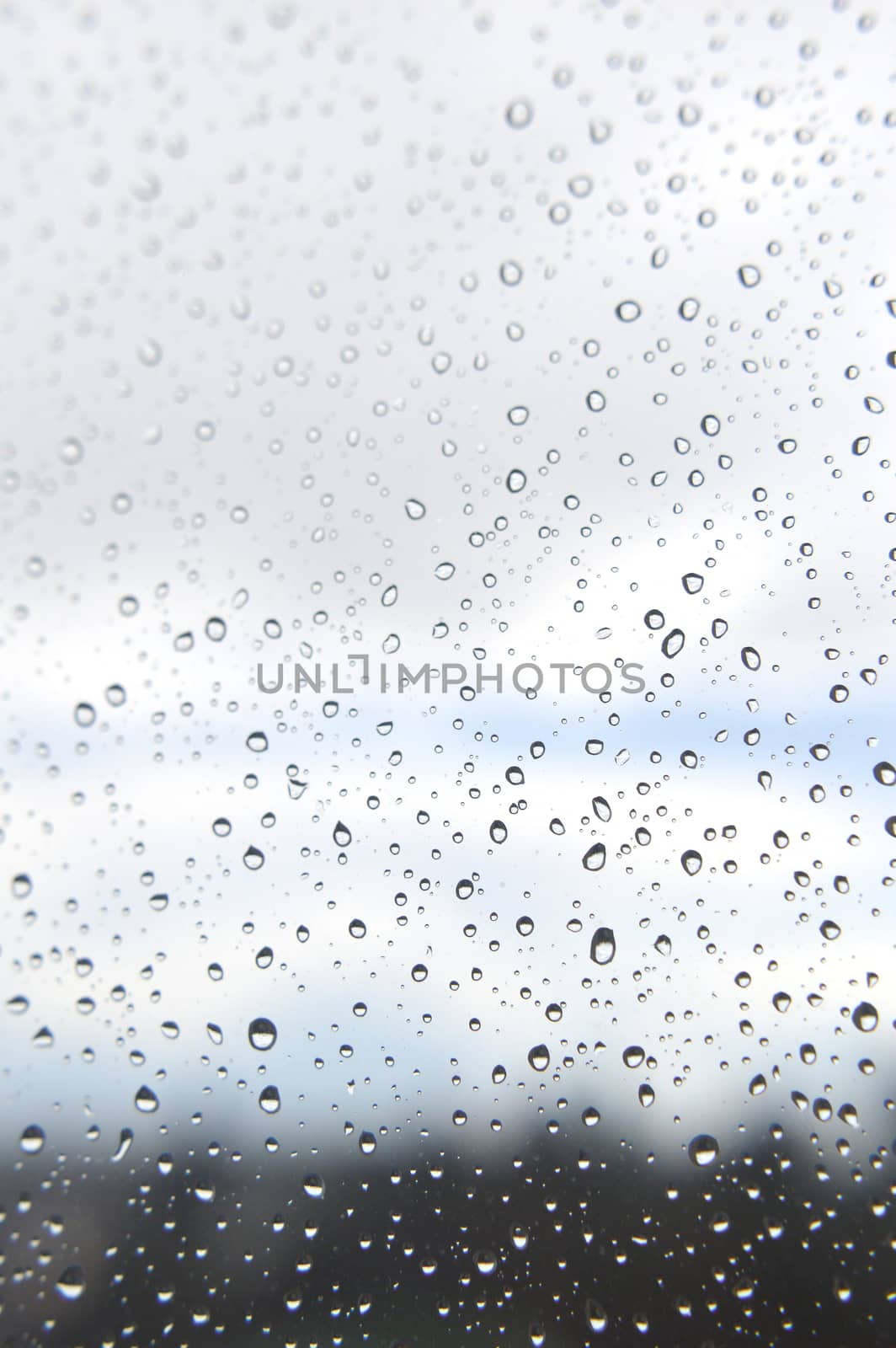 Drops of rain on the window, rainy day. Shallow DOF