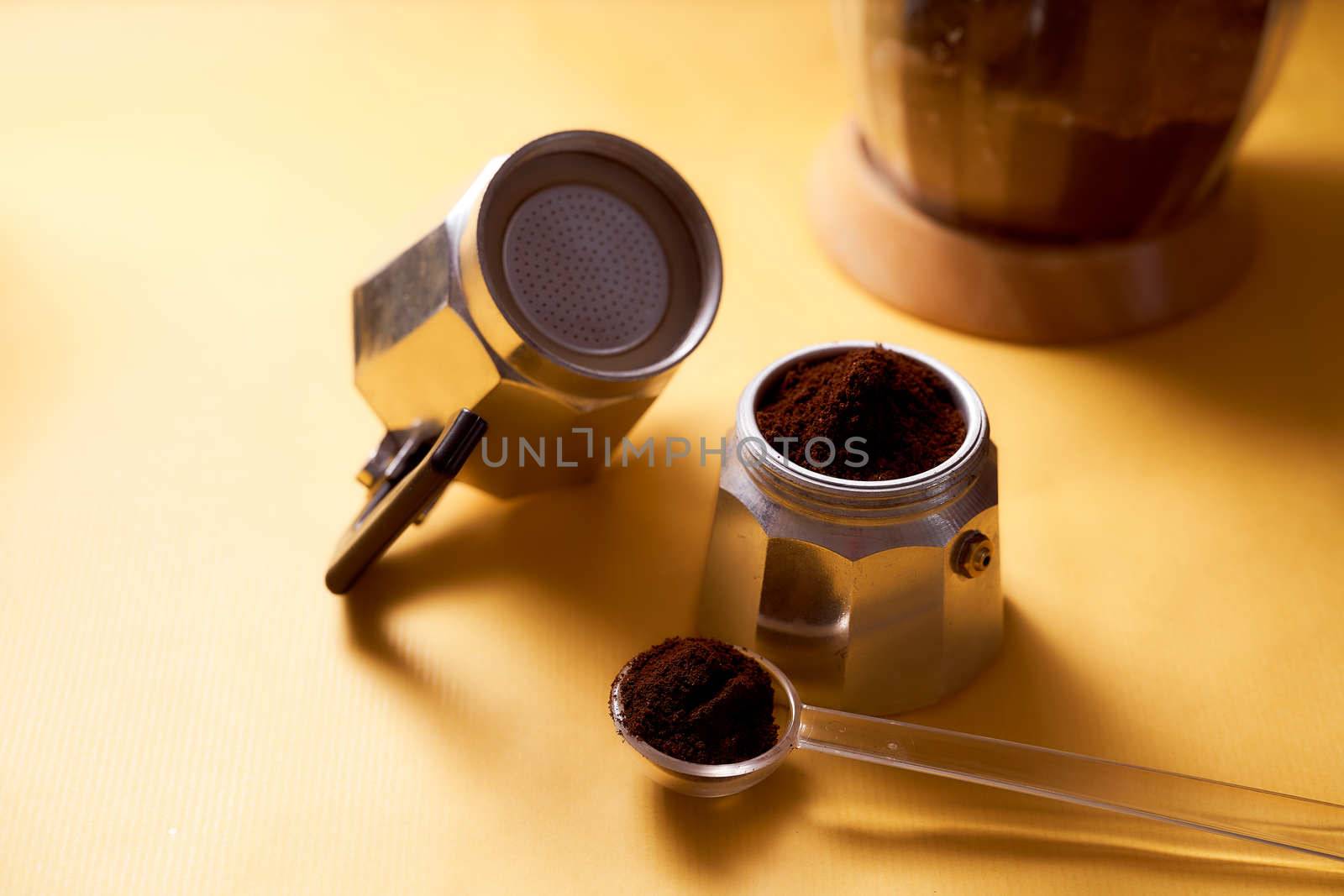 Open geyser coffee maker with fresh coffee on a yellow background. High quality photo