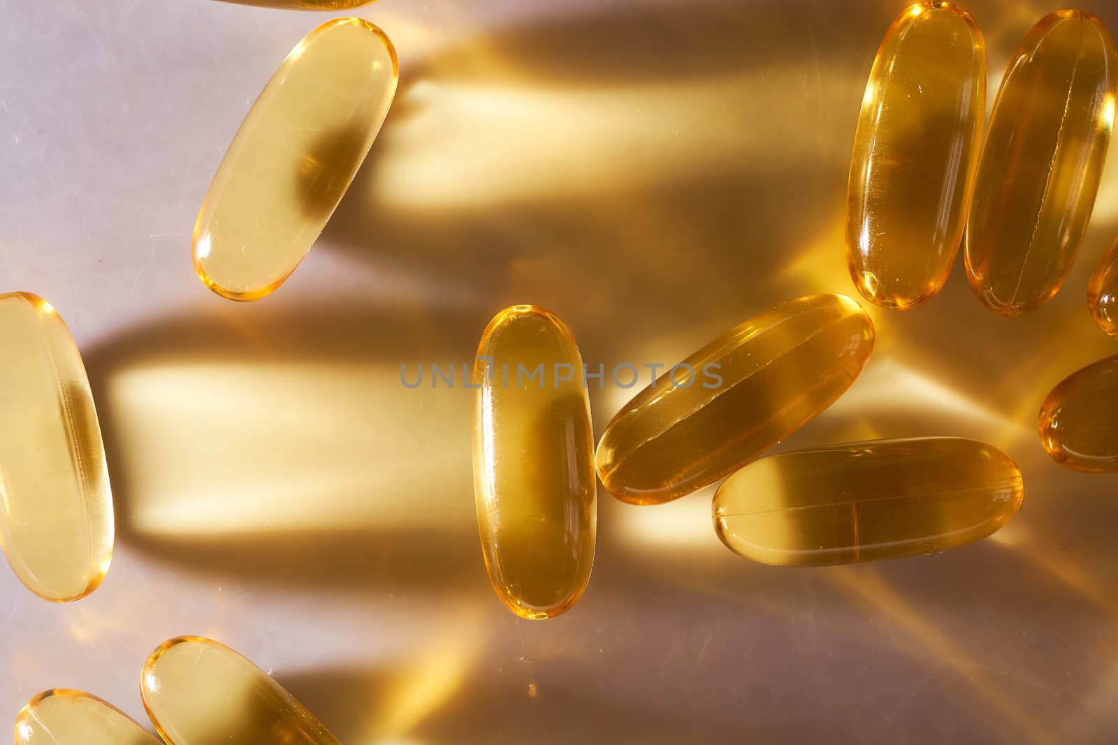 Golden Capsules Omega 3 Vitamins Lie On White Background. High quality photo