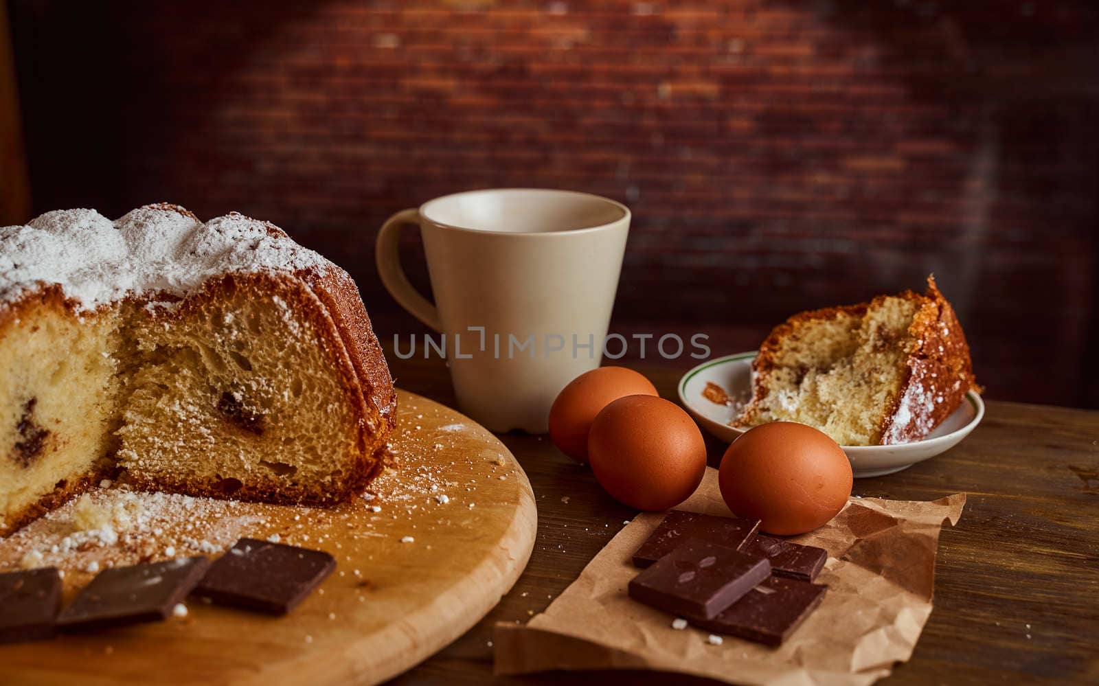 Chocolate cakes stacked on a wooden table. next to it are eggs and pieces of chocolate. blurred background. High quality photo