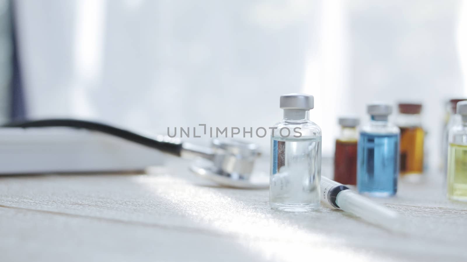 Vaccine bottles placed on the doctor's desk. At the lab in the hospital