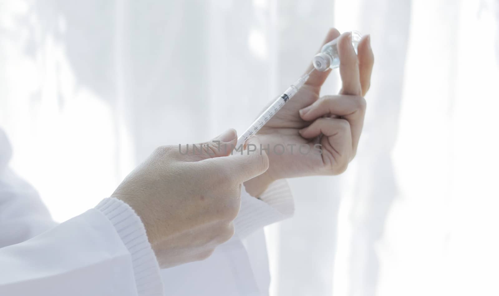 doctor's hand has a vaccine bottle Medicine concept