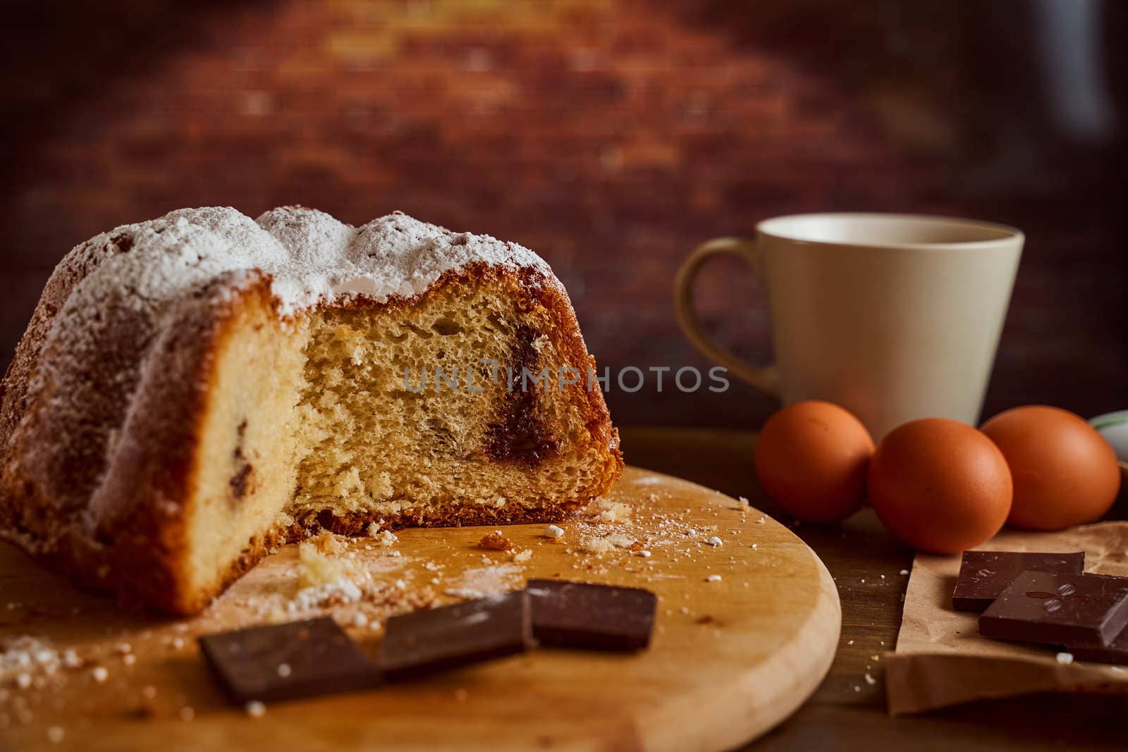 Cut homemade cupcake with chocolate cream inside on a wooden board. High quality photo
