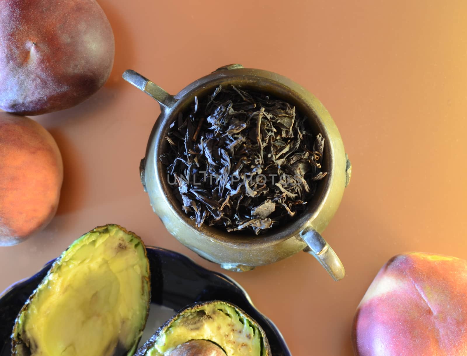 retro-style dessert with free space: peaches, a copper jug of large leaf tea and coconut