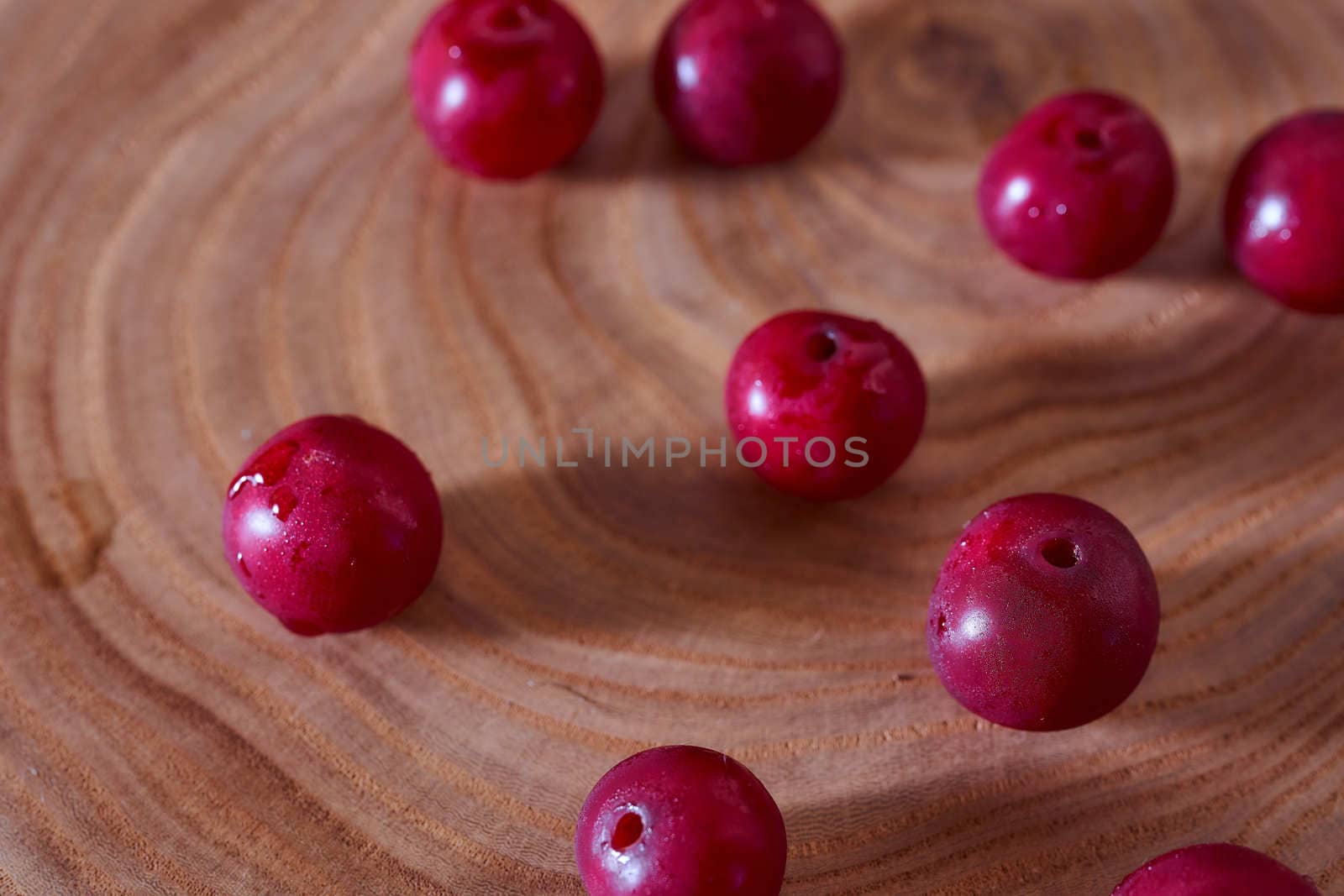 Ripe cherry berry on a wooden slice of wood. High quality photo