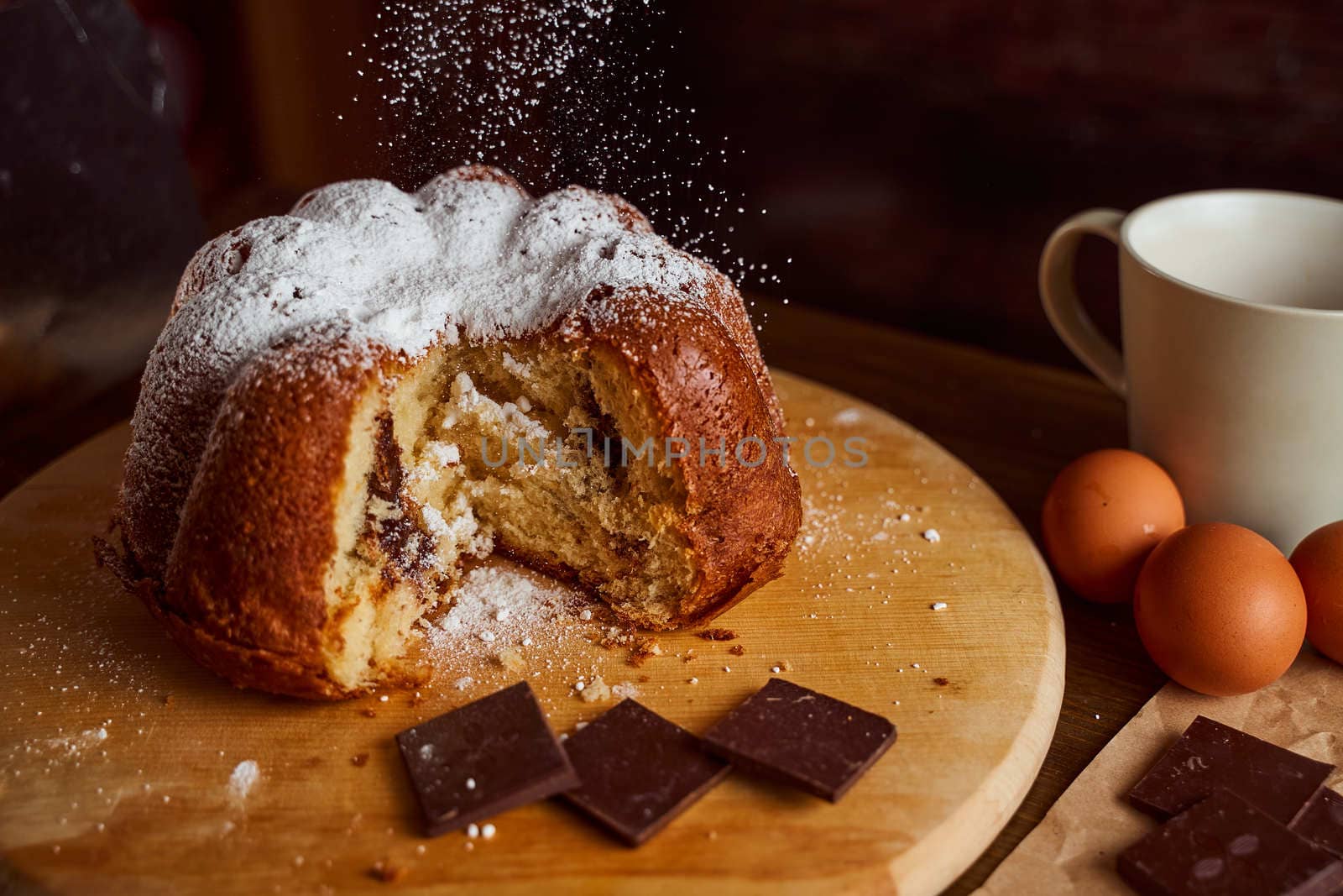 Cut homemade cupcake with chocolate cream inside on a wooden board. High quality photo