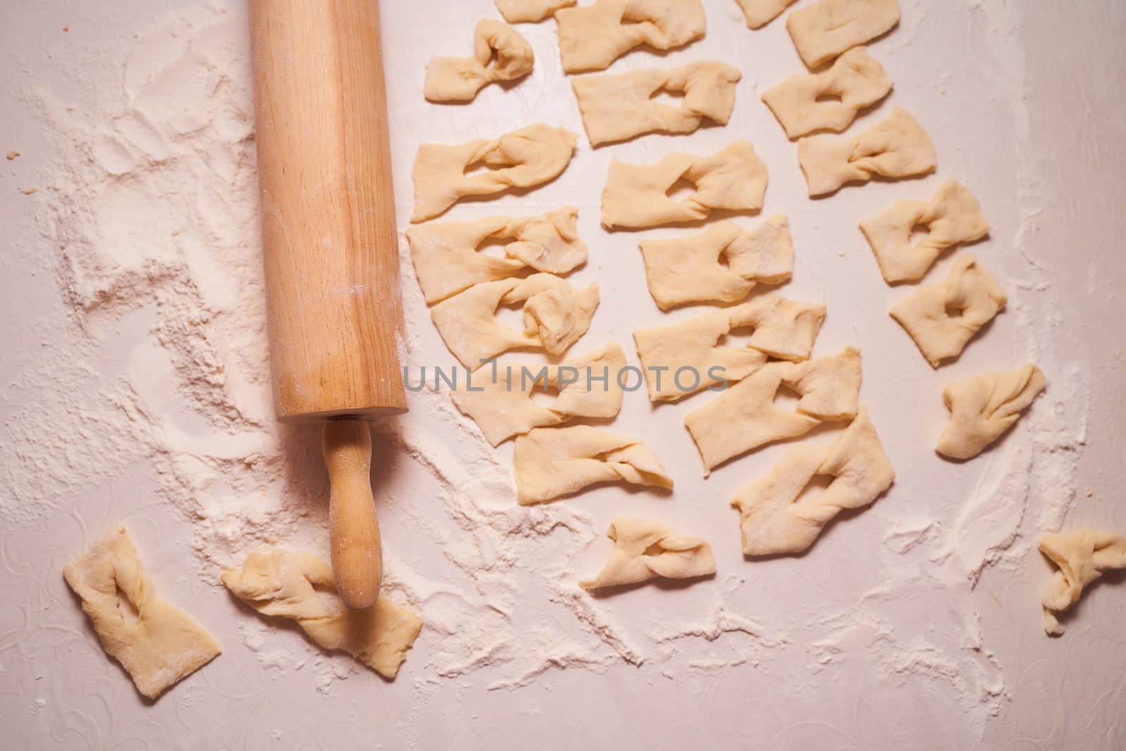 Homemade pastry, sprinkled with powdered sugar on a light table. High quality photo