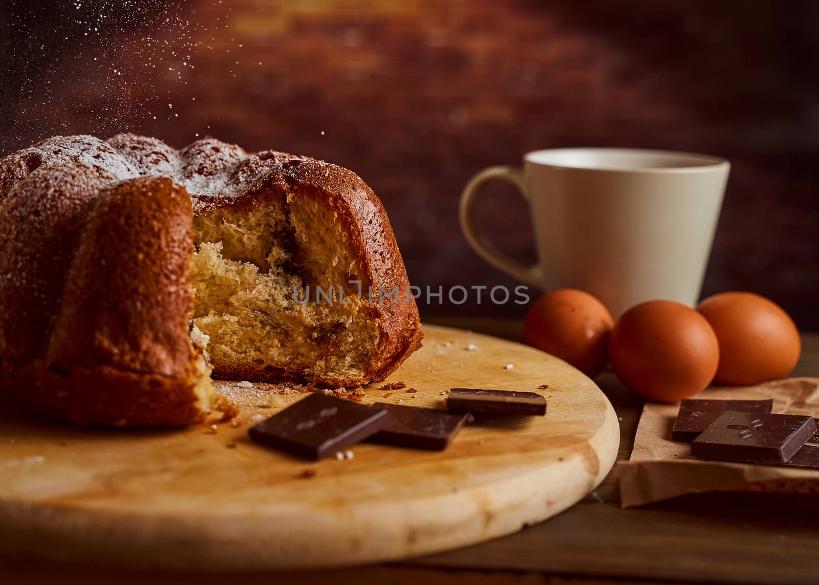 Cut homemade cupcake with chocolate cream inside on a wooden board. High quality photo