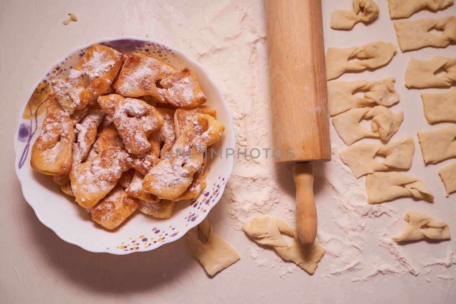 Homemade pastry, sprinkled with powdered sugar on a light table. High quality photo