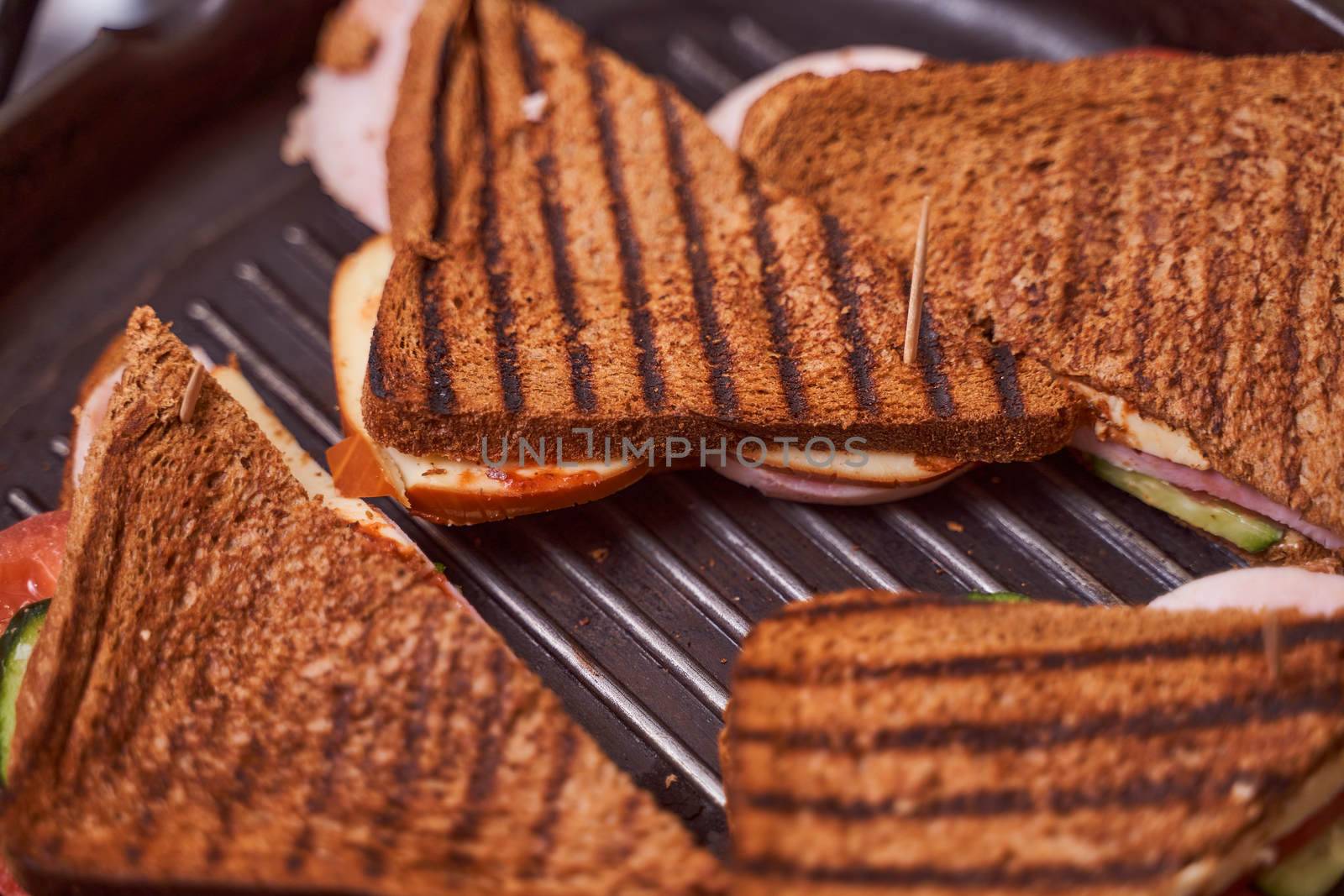 Homemade sandwiches lie on the groa grill. High quality photo