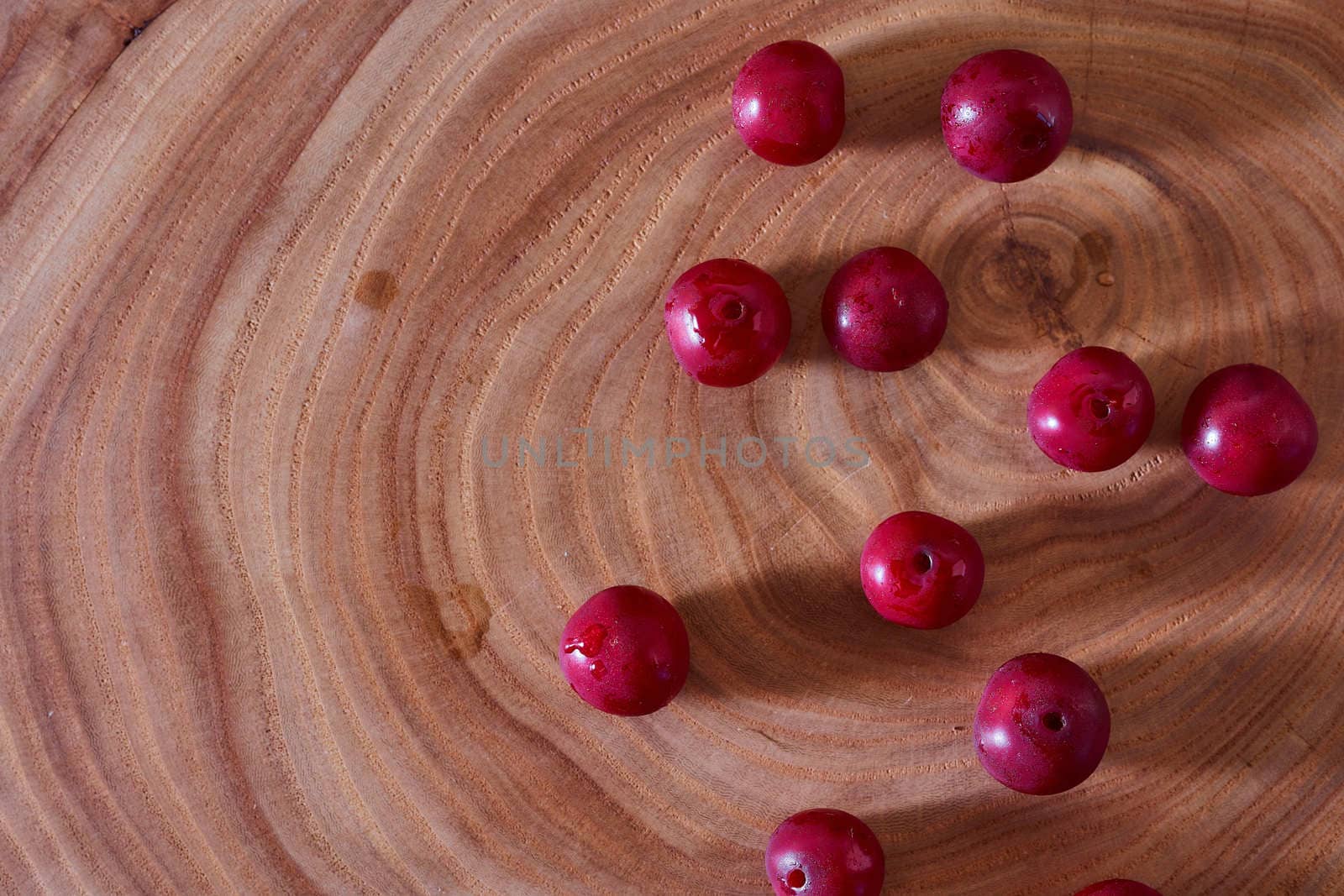 Ripe cherry berry on a wooden slice of wood. High quality photo