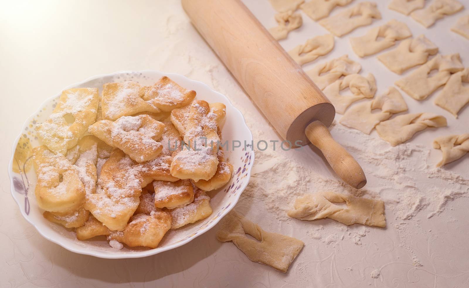 Homemade pastry, sprinkled with powdered sugar on a light table. High quality photo