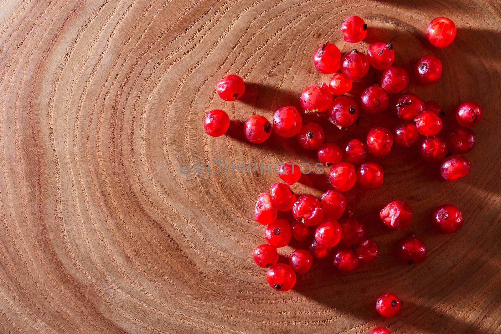  Red currants on wooden background. With copy space. Close-up. Top view. High quality photo