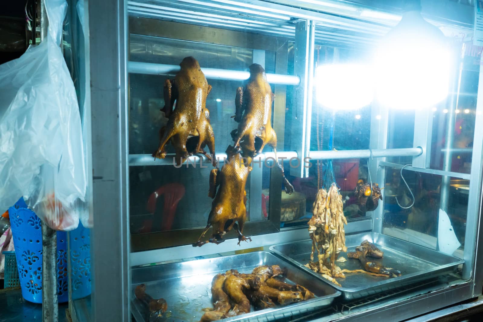 Smoked duck glass box. Food street seller in Bangkok