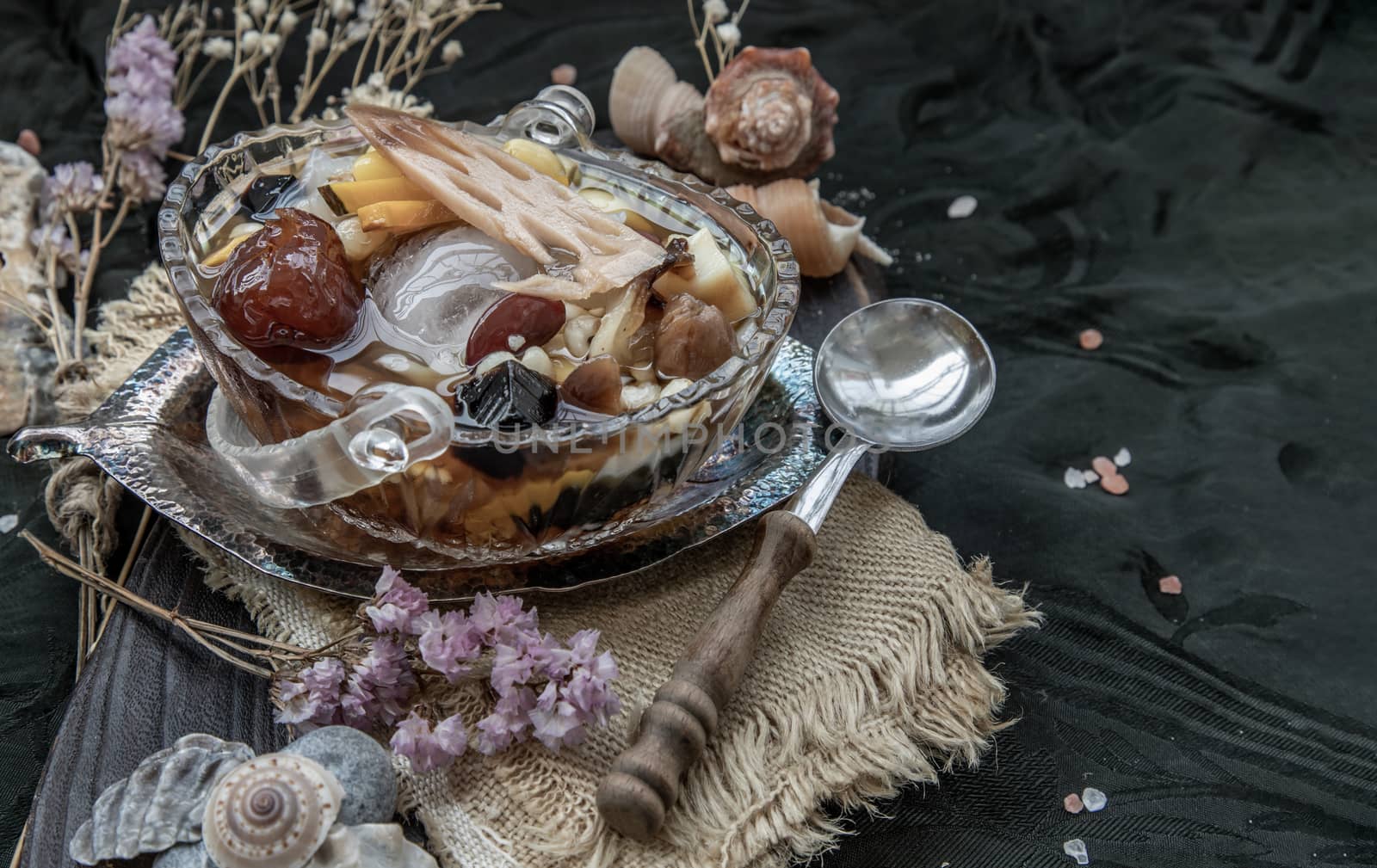 Sweet dessert : kind of Chinese dessert with boil sugar syrup is delicious here are many grains, including green beans, lotus seeds, millet, persimmon, jelly, longan, boiled flour and sugar add more cool feeling with ice. Copy space, Selective focus.