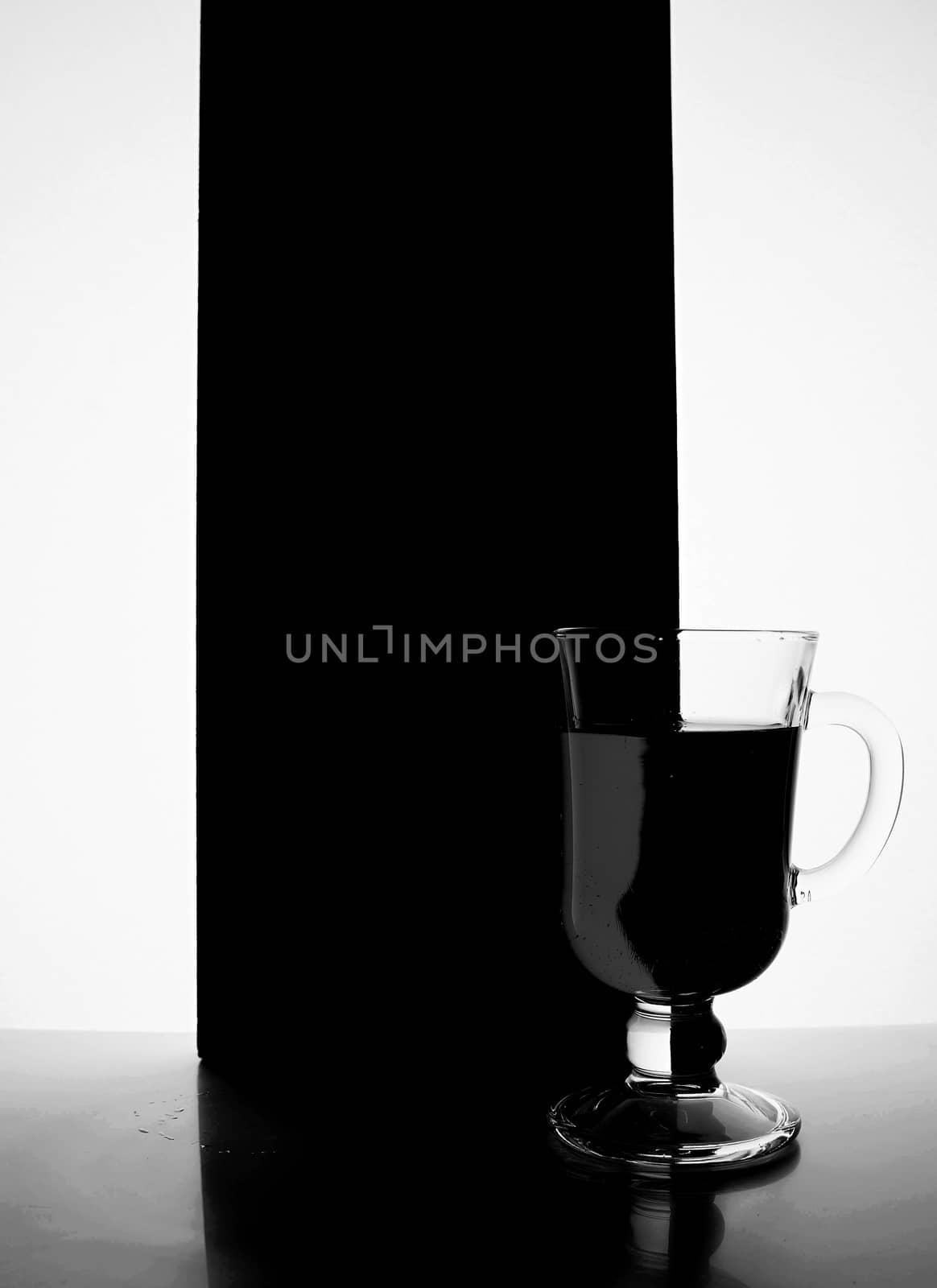 red glass with liquid on a black white background. Stylish photo. Hight quality photo