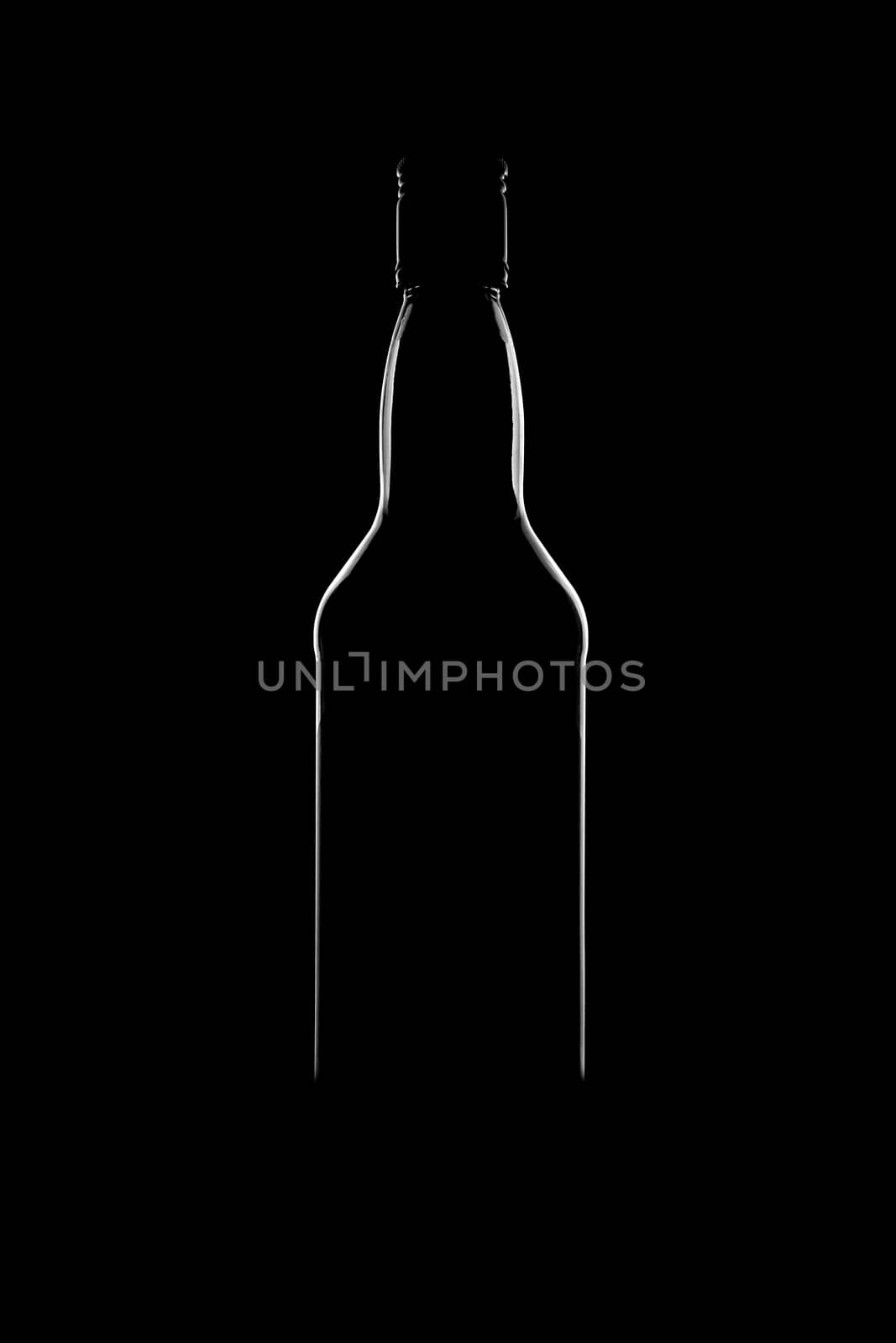 Silhouette of a bottle with a beautiful shape on a black background. High quality photo