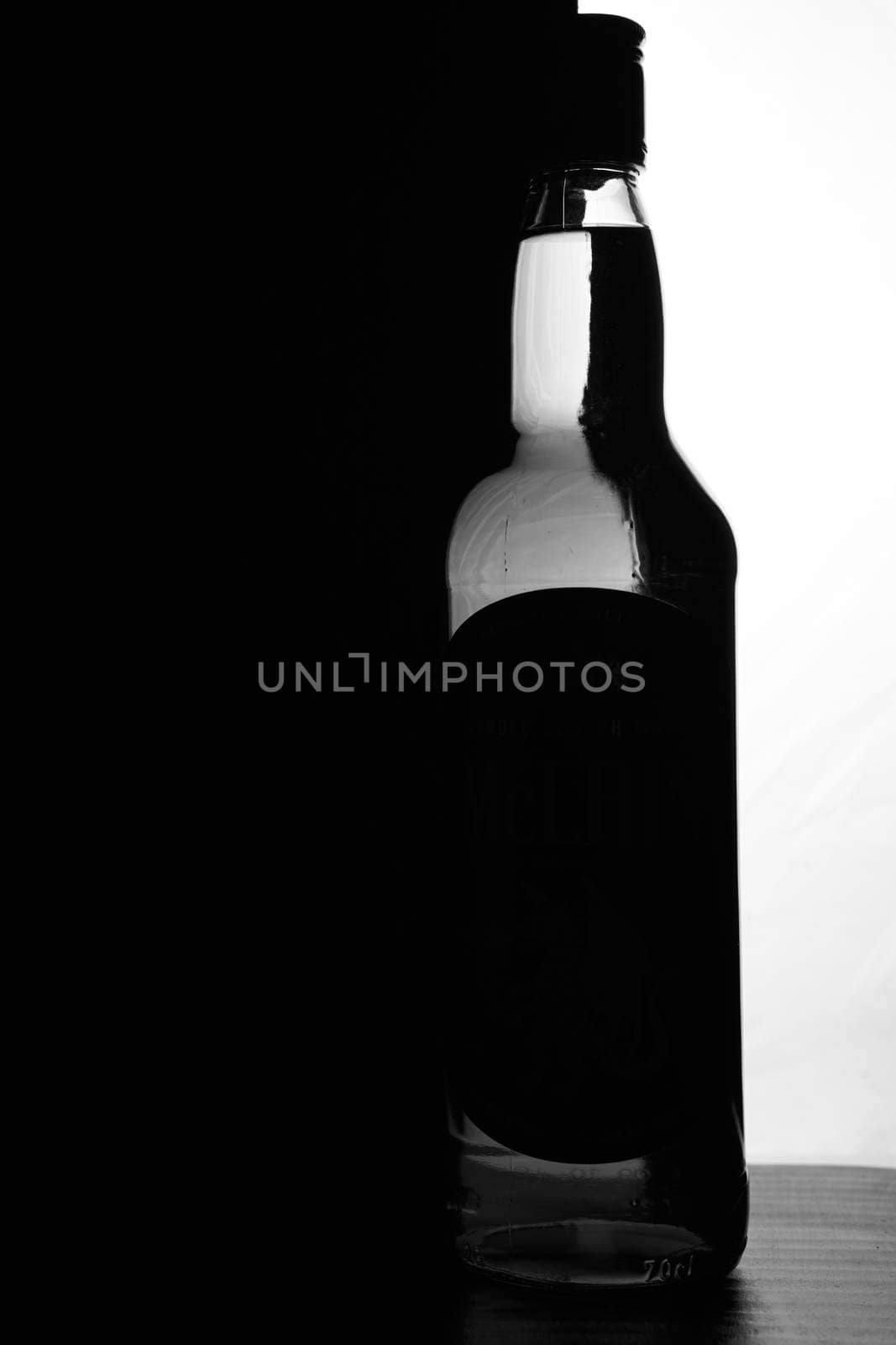 A bottle of whiskey on a black and white background. Optical effect. High quality photo