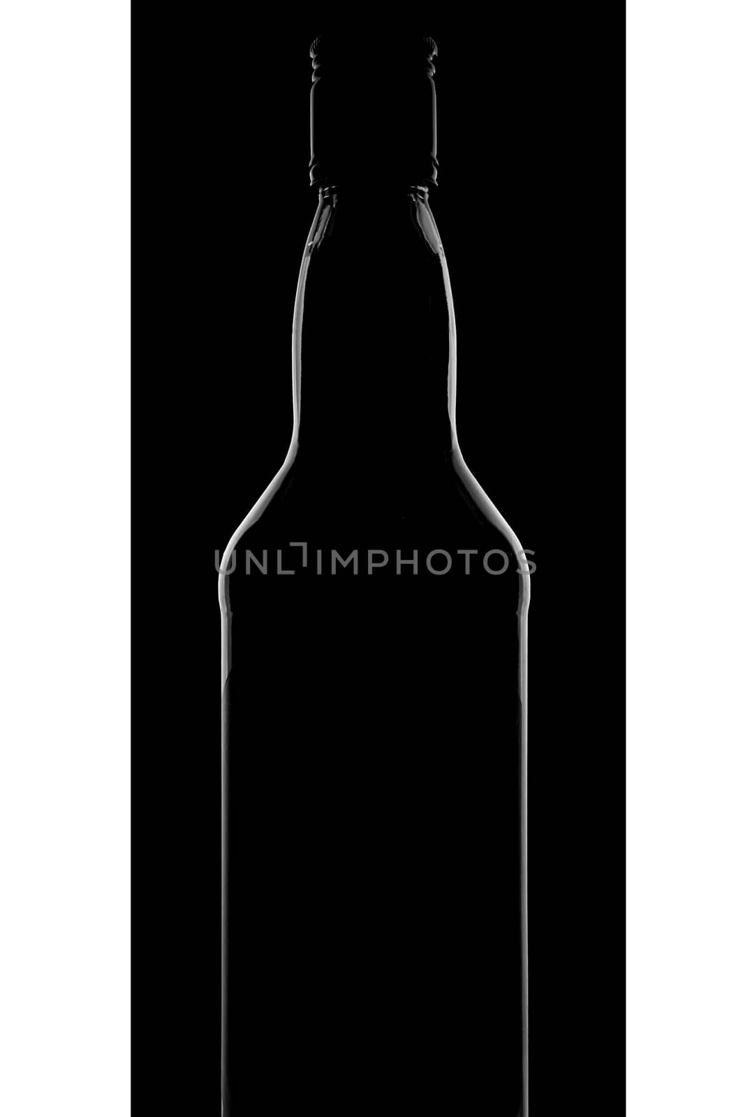 The silhouette of a bottle of whiskey on a black background. Beautiful photo . High quality photo