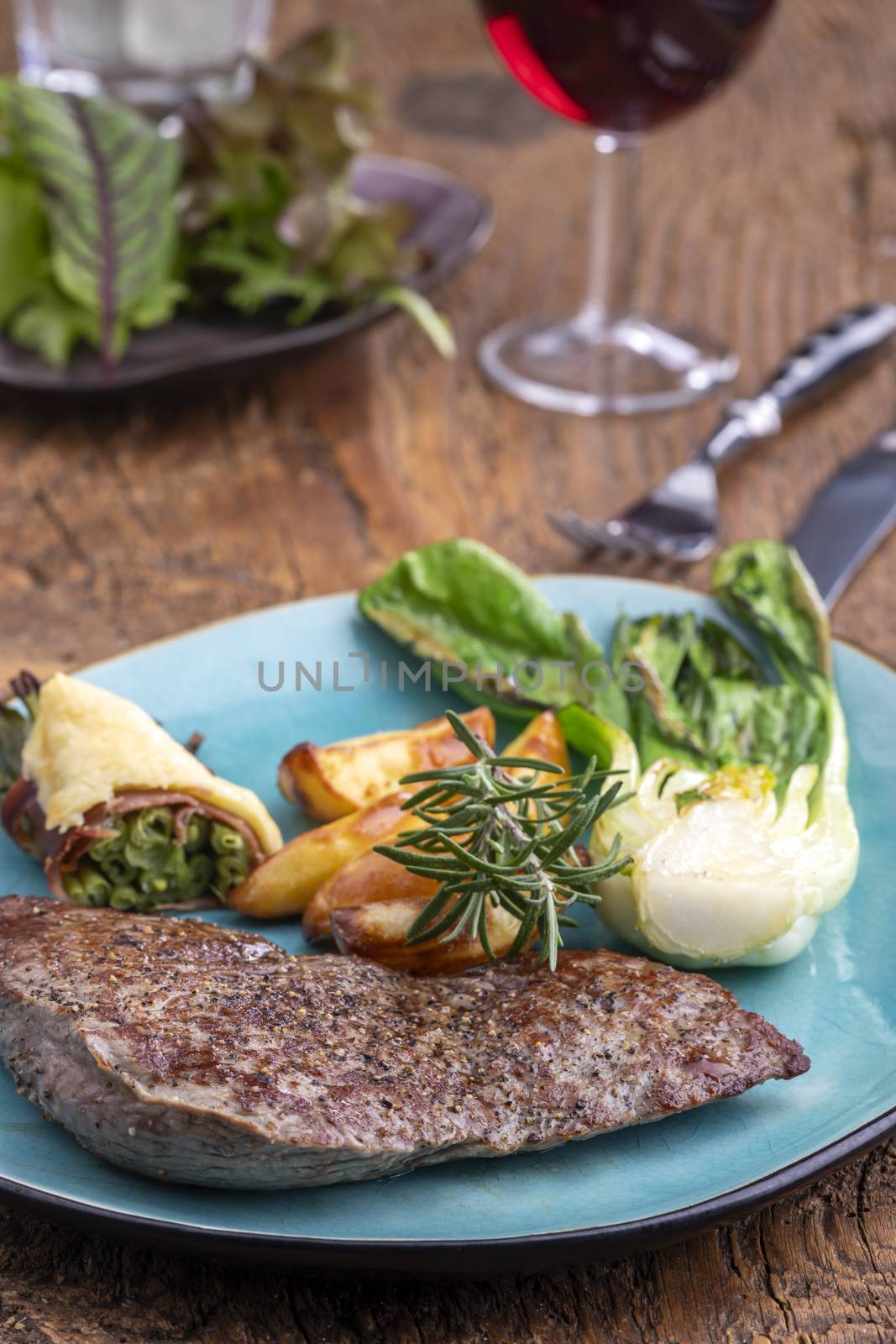 steak on a plate with vegetables by bernjuer