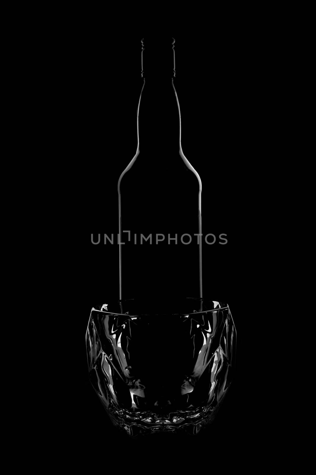 silhouette of a whiskey bottle with a whiskey glass. beautiful shape on a black background. High quality photosilhouette of a whiskey bottle with a whiskey glass. beautiful shape on a black background. 