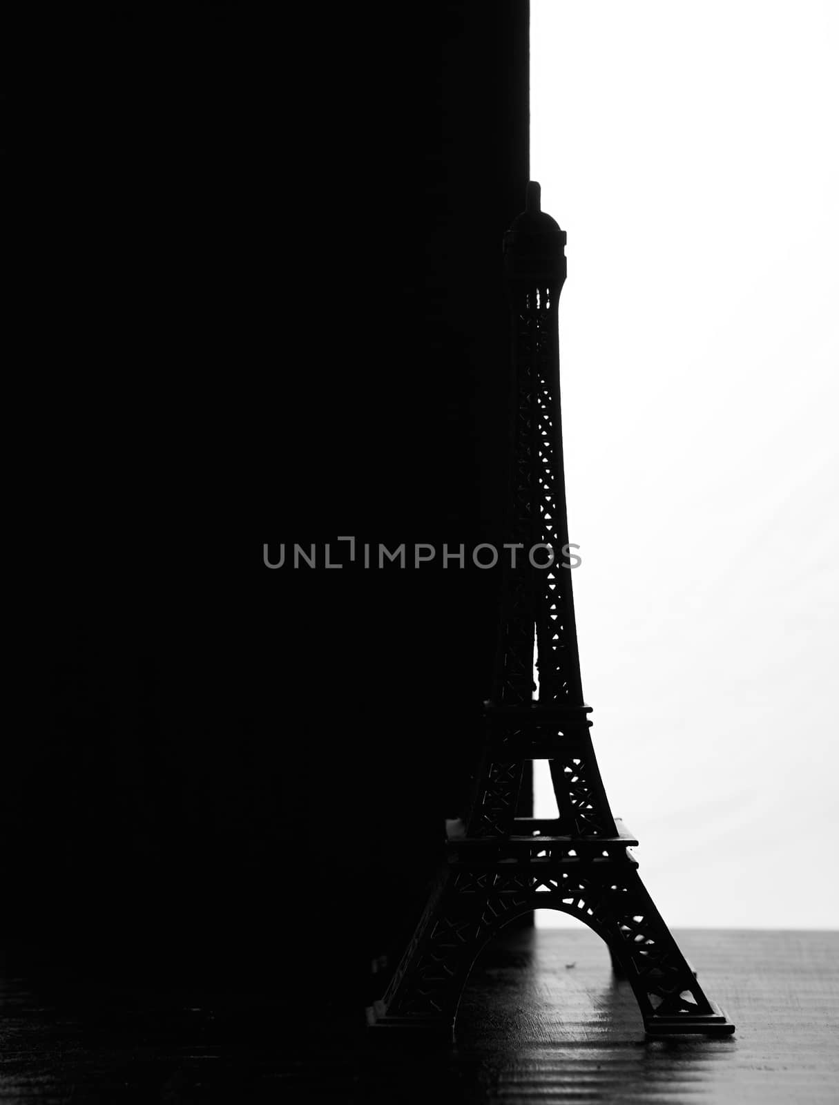 The silhouette of the eiffel Tower figurine on a black white background. High quality photo