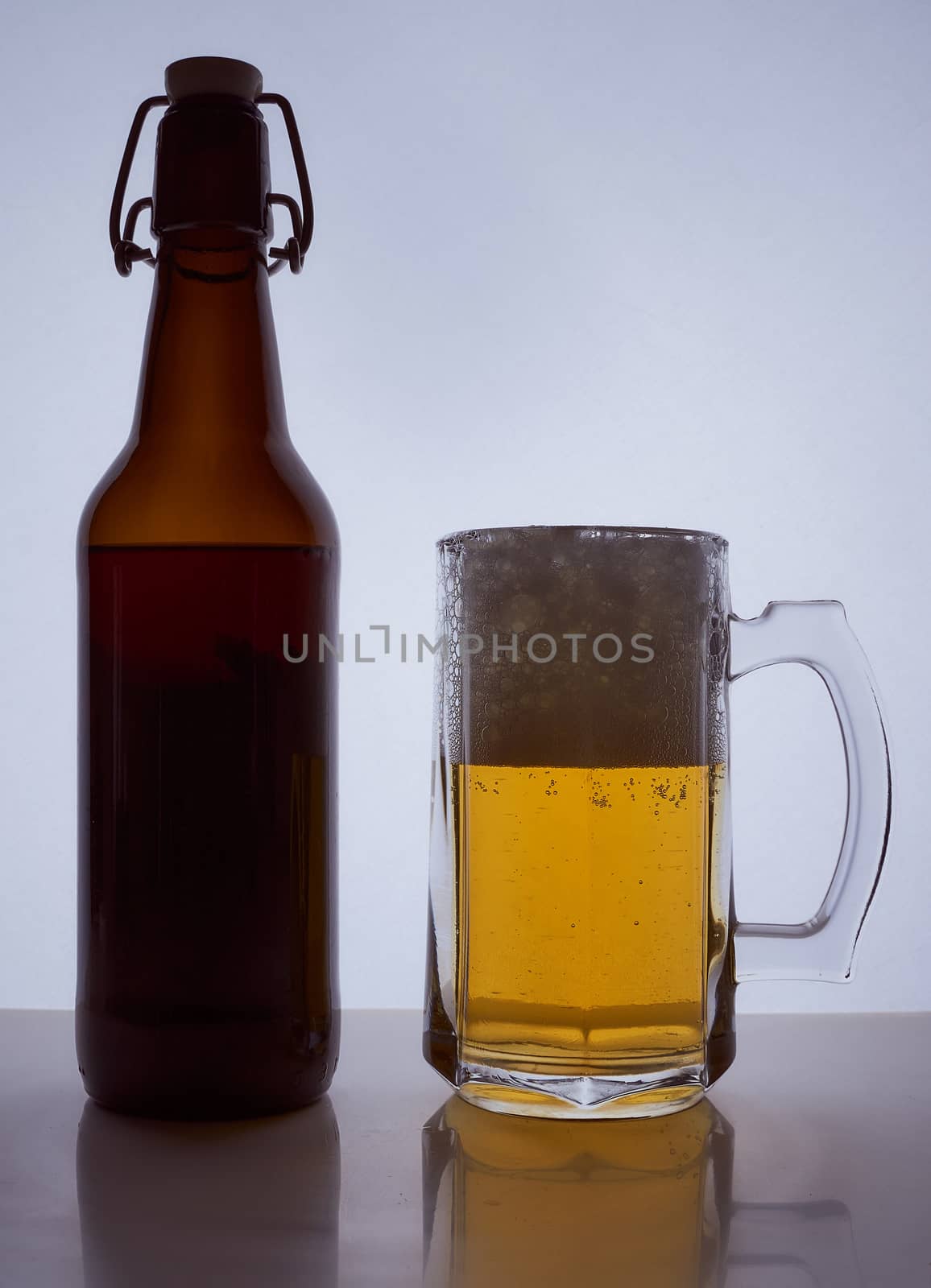 colored silhouette of a beer bottle with a cork and beer mug with beer poured into it on a black white background. Hight quality photo