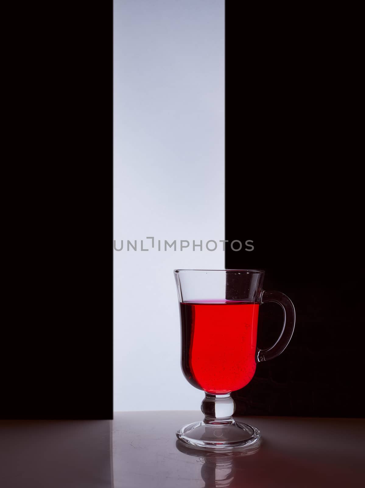 red glass with red liquid on a black white background. Stylish photo. Hight quality photo