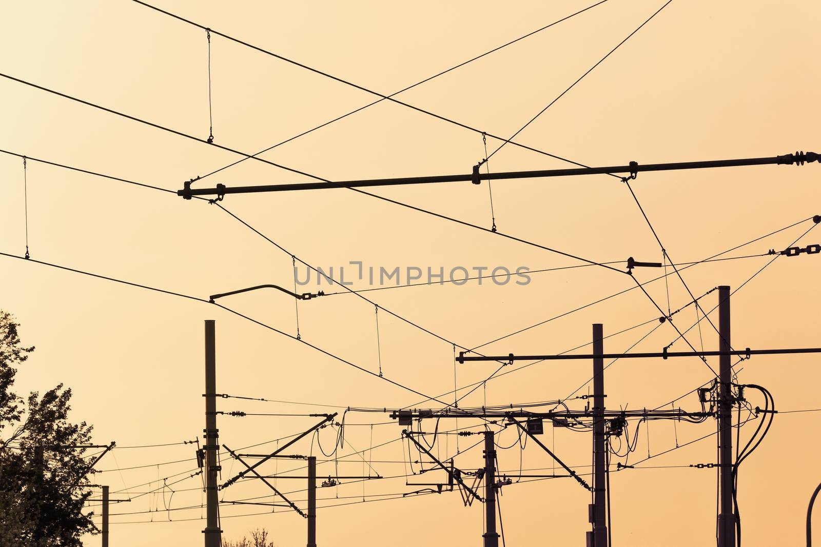 Tram  cables at sundown.Tramway overhead traction photo. Electric, transport wires photography.  Transportation infrastructure at sunset in downtown . Urban traffic wire structure.