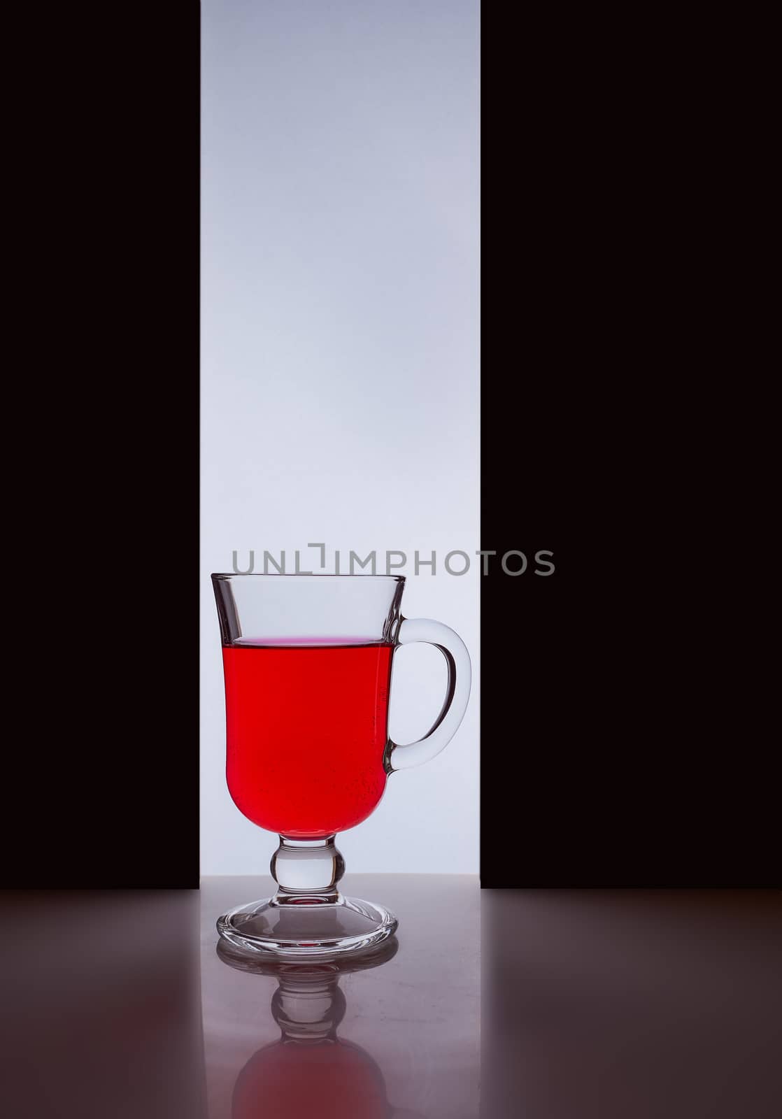 red glass with red liquid on a black white background. Stylish photo. Hight quality photo