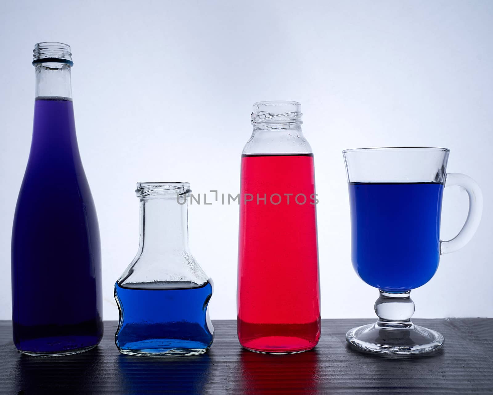 bottled on a light background with blue liquid. Hight quality photo