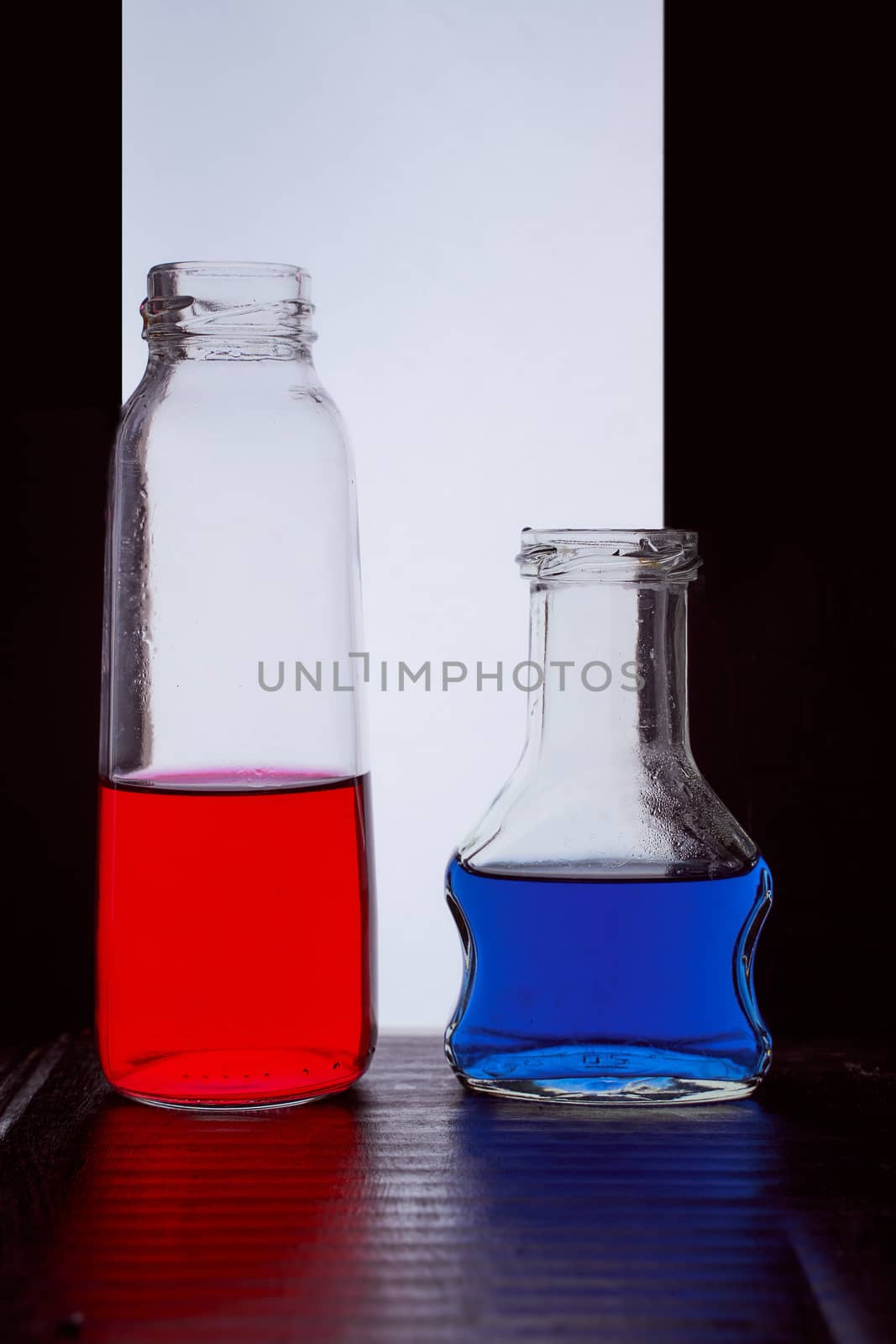 bottled on a light background with blue liquid.silhouette photo. Hight quality photo