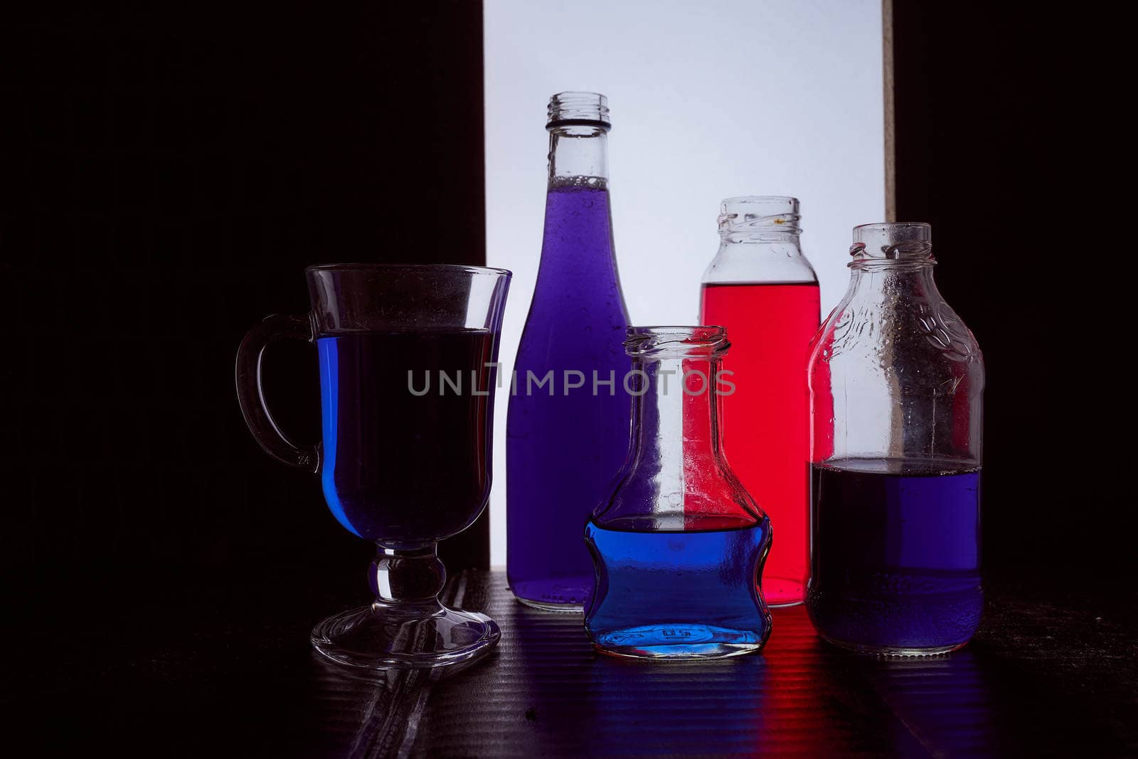 bottled on a light background with blue liquid.silhouette photo. Hight quality photo